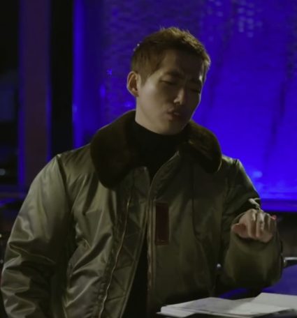 Nam Goong Min wears his scooter jacket in a moodily lit bar