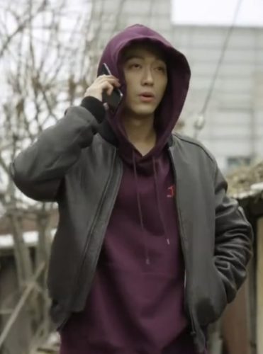 Nam Goong Min wears a maroon hoodie, hood up, with a gray jacket