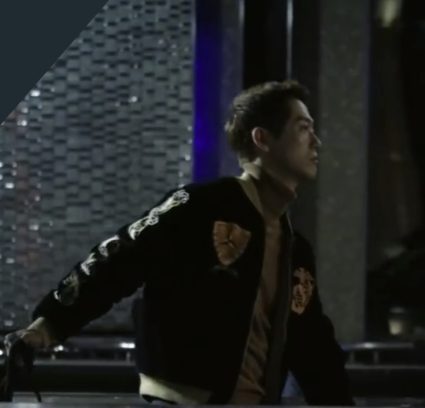 Nam Goong Min in a navy and gold varsity jacket, striding to a fight