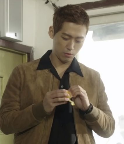 Nam Goong Min wears a deep tan suede jacket with a black extended collar shirt