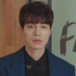 Lee Dong Wook in a navy overcoat over a black shirt with metallic collar tips